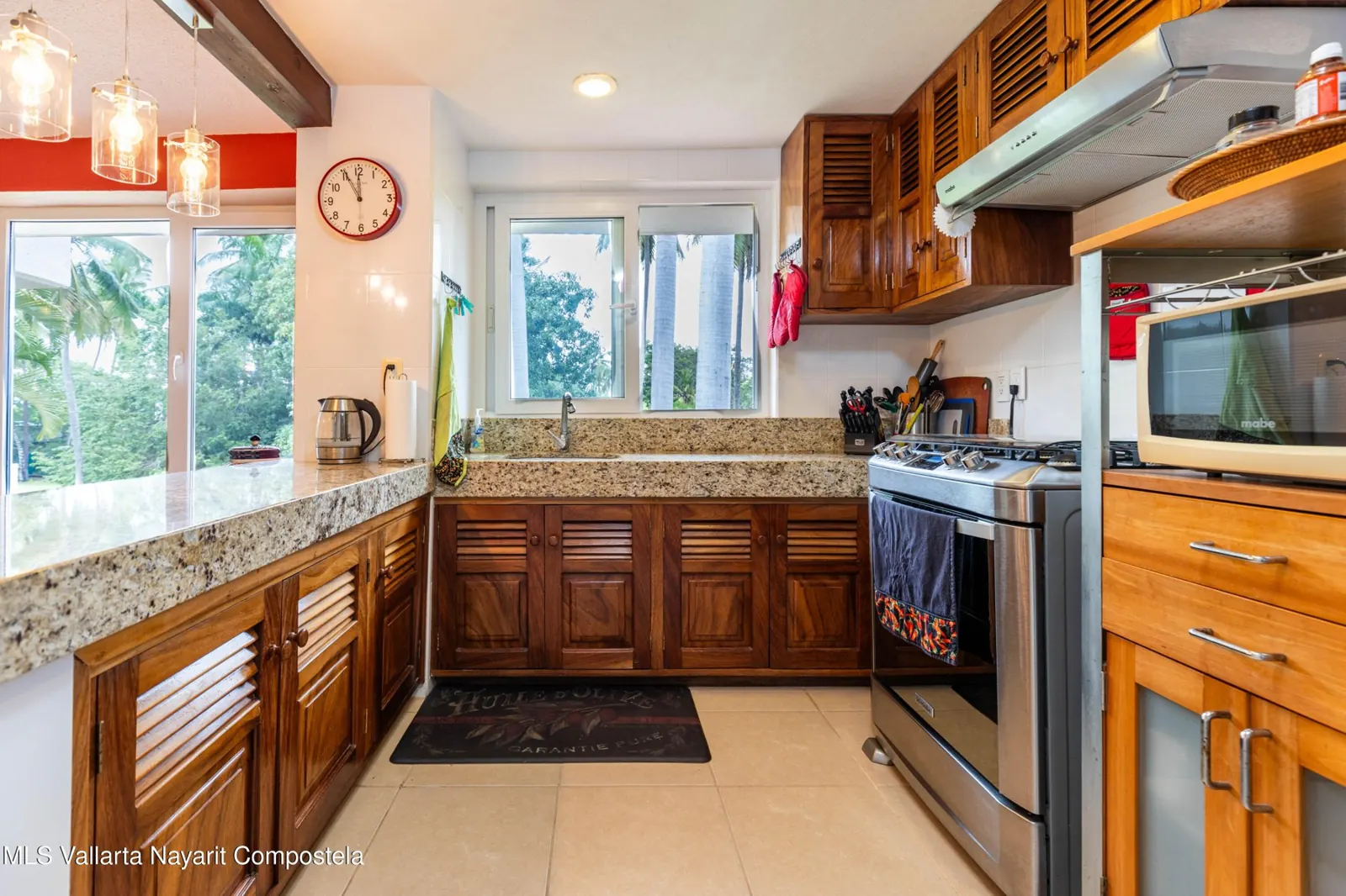 Kitchen of the Bugambilias penthouse, with a granite counter