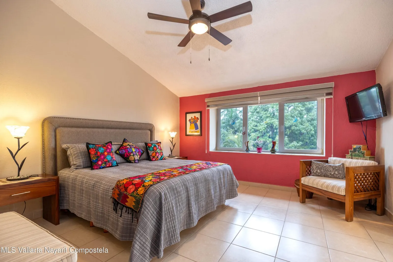 Main bedroom of the Bugambilias penthouse, with a ceiling fan