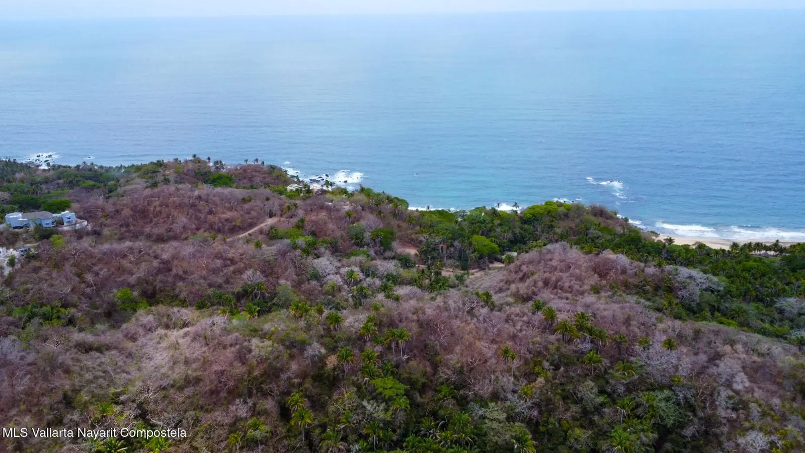 Aerial view of a long beach and a headland, included with the listing for the lot south of Sayulita.