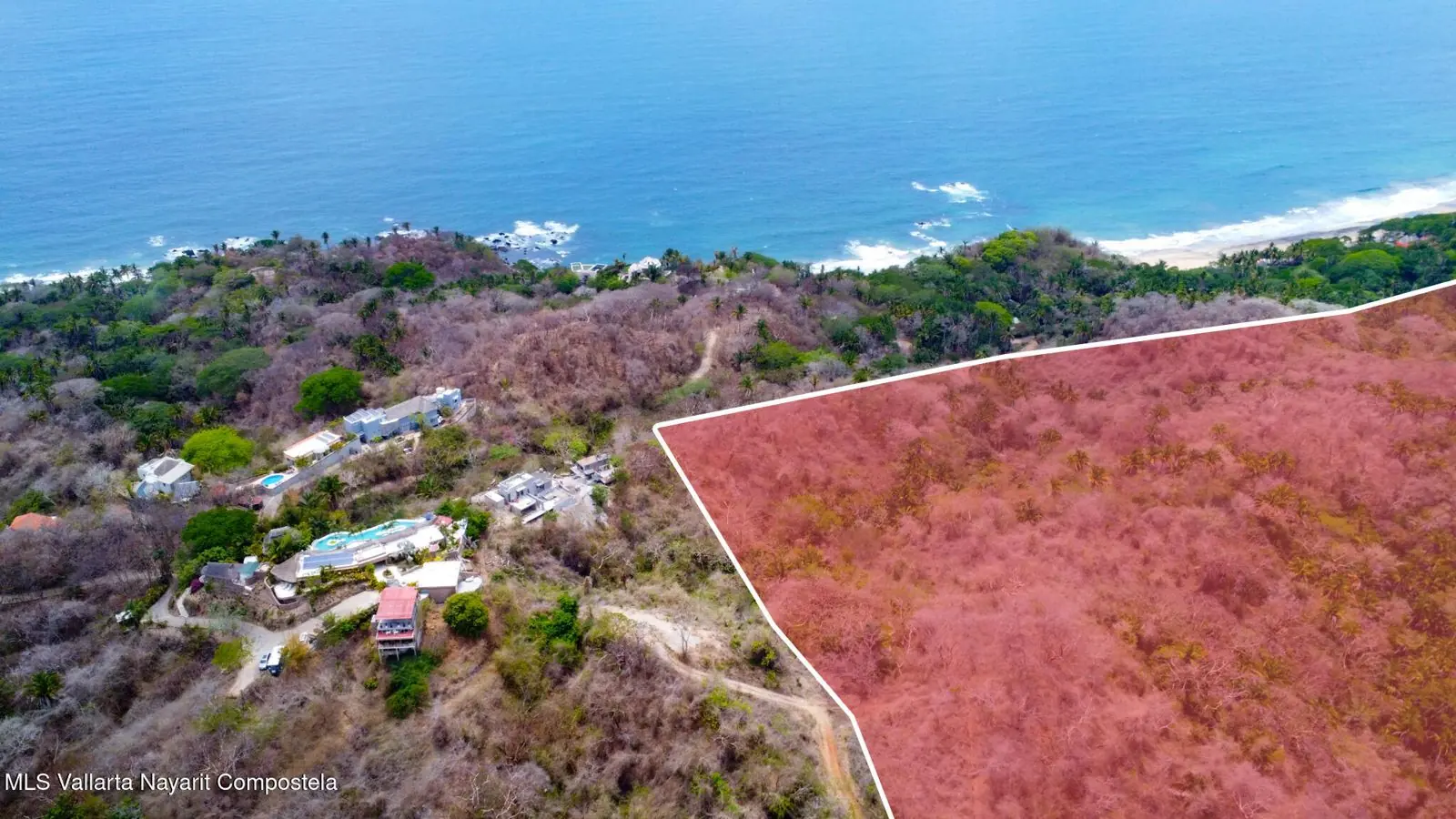 Aerial view of a vegetated headland and a beach, included with the listing for the lot south of Sayulita.